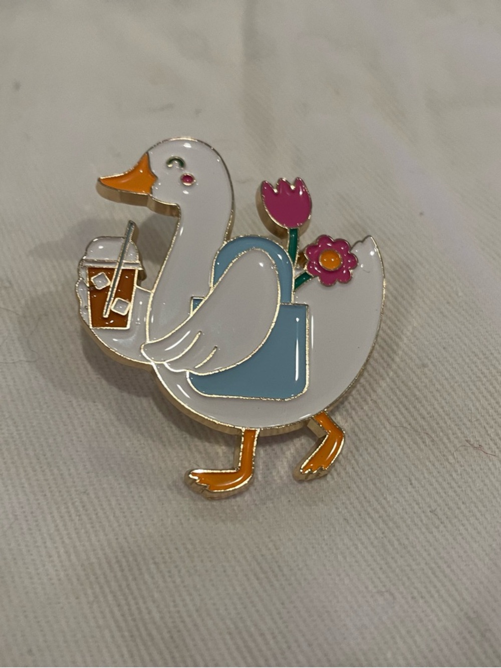 White Duck Enamel Pin with Blue Bag and Pink Flowers - Cute Bird Accessory